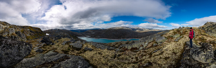 Visiting Norway Hiker admires Skalavatnet Lake Suldal, Norway Panorama