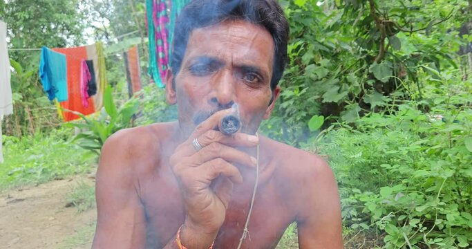 Indian Village man taking or smoking Chilum(Marijuana, Cannabis.