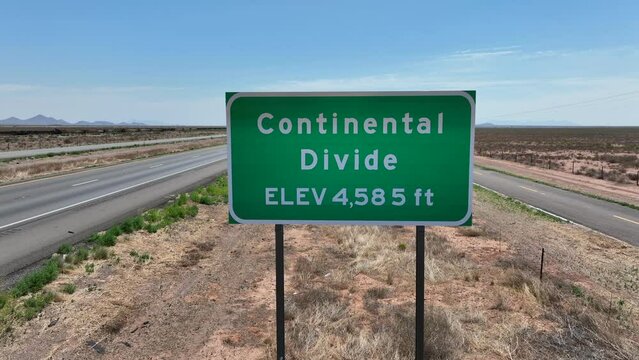 Continental Divide sign. Elevation 4,585 feet. Aerial establishing shot of continental divide line in desert in USA.