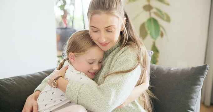 Love, mom and girl hug with a smile or bonding, support and child care for mama with happiness in on living room sofa. Mother, daughter and happy embrace on home couch and quality time together