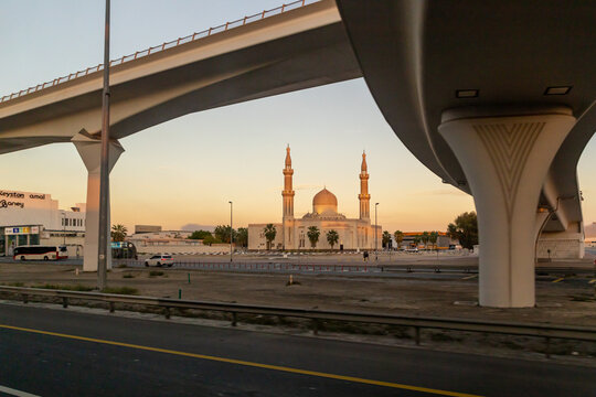 View at sunset from the window of a tourist bus on the Al Khair Masjid mosque and other architecture of the city of Dubai, United Arab Emirates