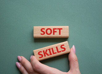 Soft skills symbol. Wooden blocks with words Soft skills. Beautiful grey green background. Businessman hand. Business and Soft skills concept. Copy space.