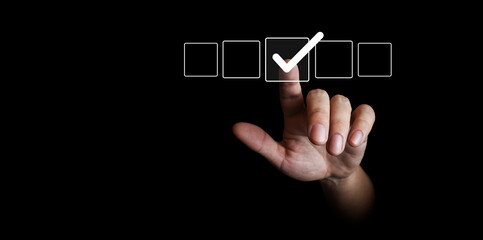 finger by placing a check mark on a list -to-do concept