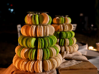 Delicious cakes of green and beige macarons. Pistachio and vanilla flavored macarons