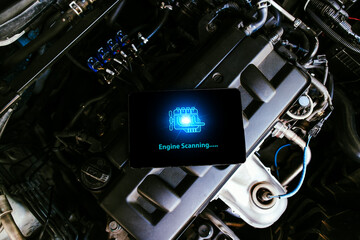 Smartphone with engine diagnostics on the screen, car repair in auto repair shop, Car maintenance...