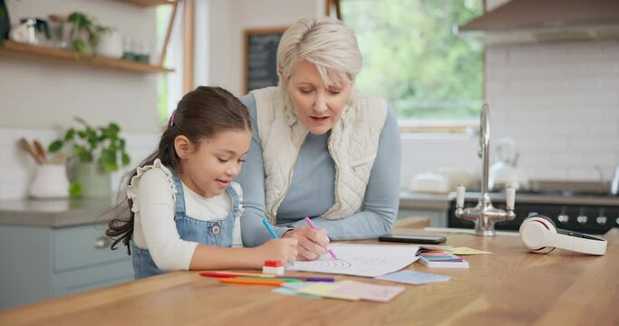 Grandmother helping a child with her homework in the kitchen for education studying for home school. Creative, e learning and senior woman drawing art picture with her girl grandchild at family house