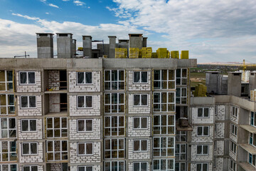 Fototapeta premium Monolithic frame construction of the building. Family mortgage. Shooting from a drone. Modern construction of a residential building. construction site close up. Multi-storey building. .