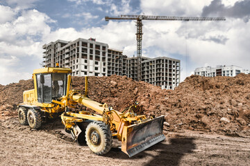 Road grader at a construction site in a quarry. Land surface planning for the construction of a new...