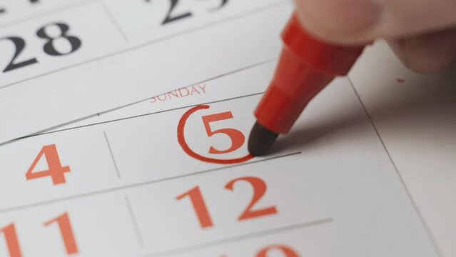 The fifth date on the calendar is boldly marked with a red marker as an important date. Close-up.
