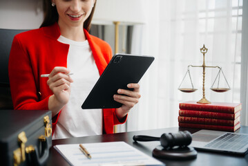 justice and law concept.Male judge in a courtroom  the gavel, working with smart phone and laptop and digital tablet computer on table