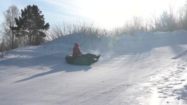Riding from a snowy mountain on a tubing