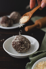 Chocolate cake in the form of a cola sprinkled with coconut