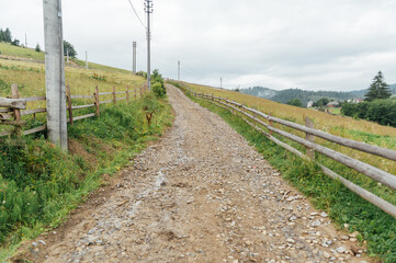 The old rocky soil road in the mountains for walking people and for driving on off -road cars