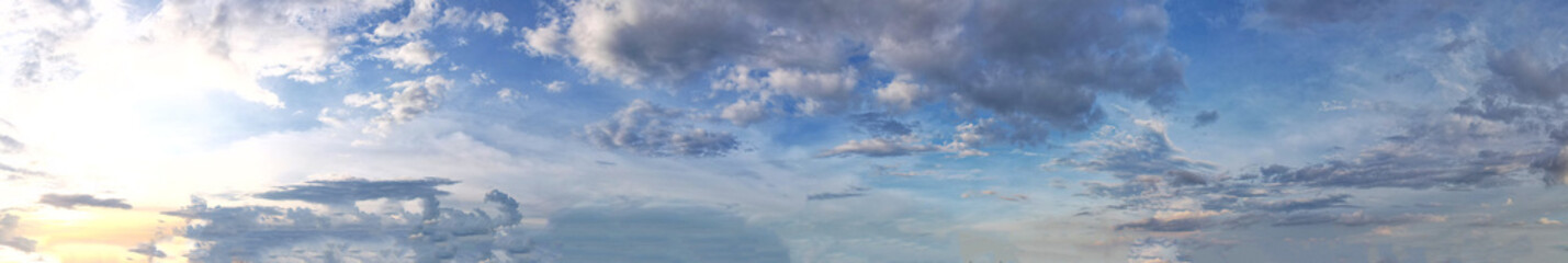 Panoramic view unveiled a breathtaking sight of beautiful blue clouds floating gracefully across the sky embraced by gentle beams of soft radiant light creating an ethereal and dreamlike atmosphere.