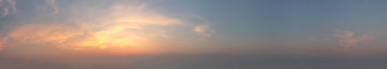 Beautiful sunset sky painted a masterpiece of vibrant hues, with streaks of gold orange casting a warm and enchanting glow upon the horizon, Panoramic view.