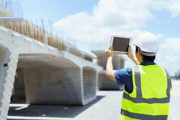 Professional senior Asian civil engineer working at the heavy infrastructure construction site.