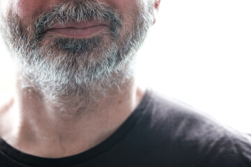 Obraz premium Close-up of grey beard of unrecognizable smiling mature man.