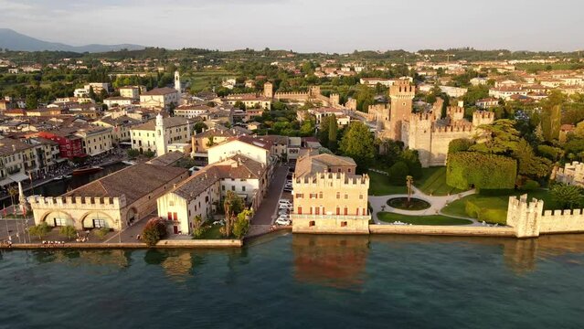 Drone shot of a crowded market at the boulevard on Lake Garda at sunset