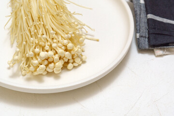 Enoki Flammulina velutipes white mushroom used i food and salads. Close up
