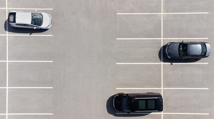 Aerial view of cars in parking places - obrazy, fototapety, plakaty