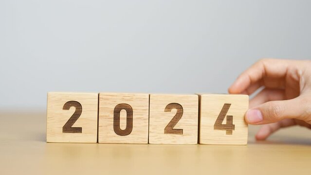 hand holding 2024 year block on table. goal, Resolution, strategy, plan, start, budget, mission, action, motivation and New Year concepts