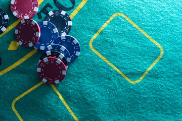 Image of several red dice falling on green table on background of multicolored spots