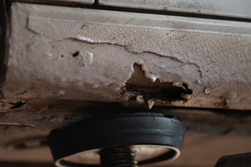 rusted car buttom,car on a car lift