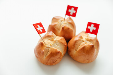 Traditional bread buns with a cut in the shape of the Swiss flag is baked in Switzerland on the eve of the National Holiday on August 1st