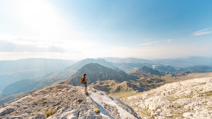Obraz premium The girl travels in the mountains.