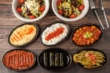 Different kinds of Turkish appetizers on white porcelain plates