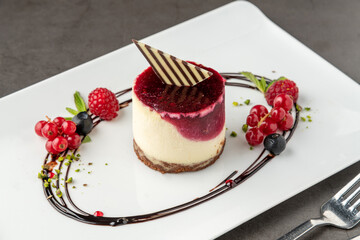 Forest fruit mini cake on a white porcelain plate