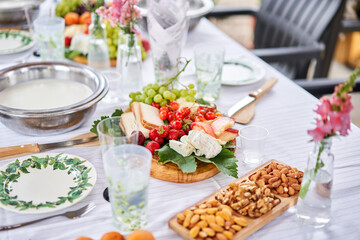 Master class and cheese tasting. Women make cheese. The enzyme and starter culture are added to the milk in a metal container. Milk folding process, home production, business, entrepreneur.