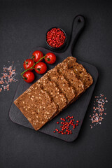 Delicious fresh crispy brown bread with seeds and grains cut into slices