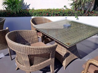 Wooden lounge table chair with cushions and mountain rim slope background