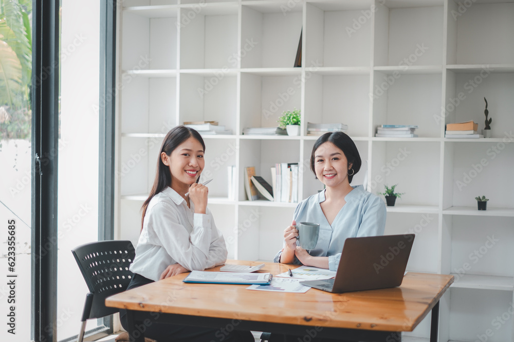 Poster portrait of a smiling group of diverse corporate colleagues analyzing documents while sitting on a t