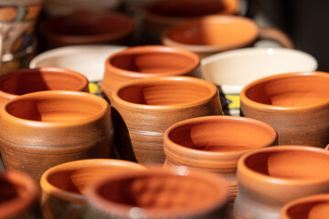 clay pots on the shelf in the store, closeup of photo