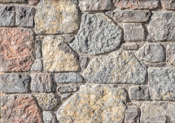 closeup of a stone wall with irregular blocks