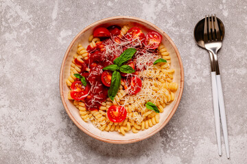 Homemade pasta with tomato sauce, top view.