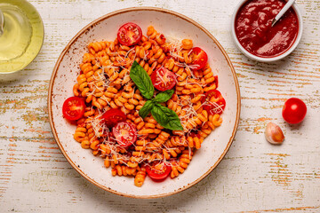 Homemade pasta with tomato sauce, top view.