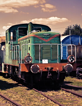 Rusty museum fablok combustion engined diesel cargo locomotive in violet scenerio 