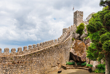 Tower and stone wall with battlements in the Moorish castle of Sintra,Portugal.