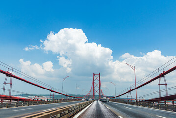 Fototapeta na wymiar 25 de Abril Bridge in Lisbon seen from the road, Portugal.