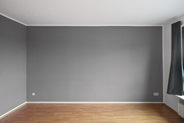 Small empty living room with gray painted walls and wood parquet in an apartment, background...