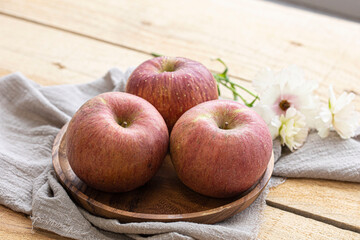 Red apple isolated on wooden background