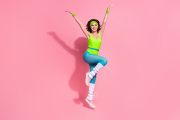 Photo of positive lady trainer jumping gymnastics tricks online blogging exercise isolated pastel...