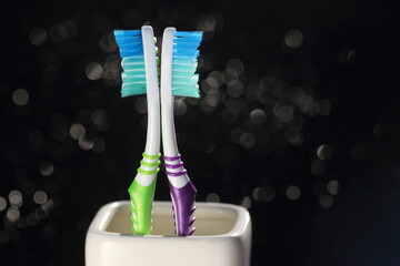 Toothbrushes isolated on the bokeh background. Nylon bristles and plastic handles. Blank copy space for advertising text.
