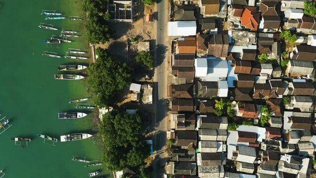 Aerial View of Village in Southeast Asia with Traditional Fishing Boats and Dense Housing