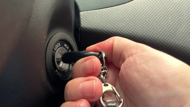 Key inserted into the lock of ignition of the car