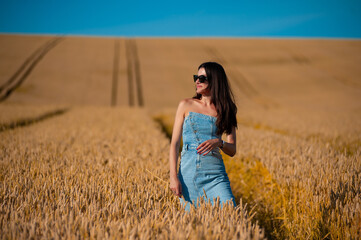 Fototapeta na wymiar beautiful young woman in golden wheat field