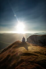 Person meditating on a mountain